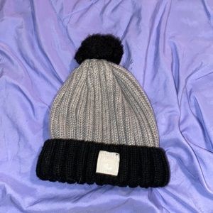 Slightly worn black and grey beanie